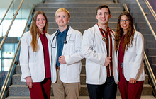 White coats and wedding rings photo of engaged students